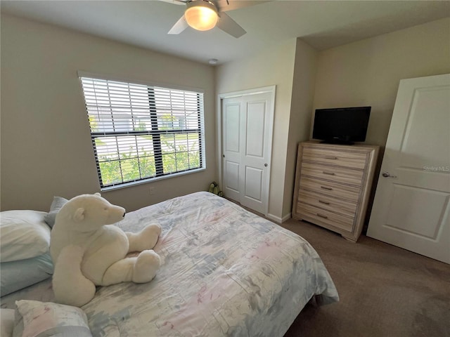 carpeted bedroom with ceiling fan and a closet