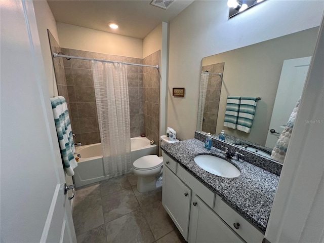 full bathroom featuring tile patterned floors, vanity, toilet, and shower / bath combo with shower curtain