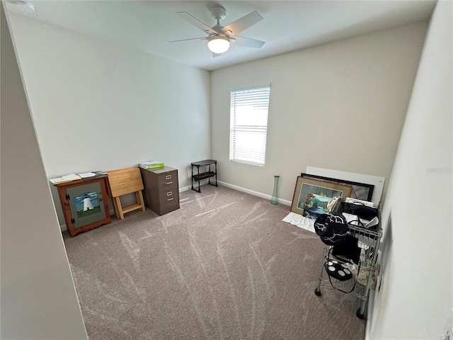 carpeted home office with ceiling fan