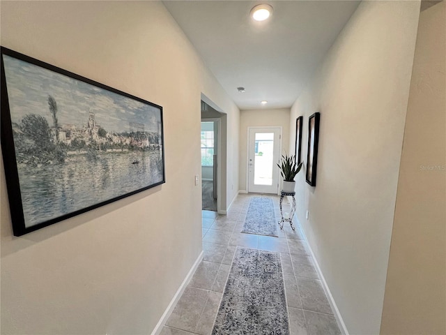 hall with light tile patterned flooring