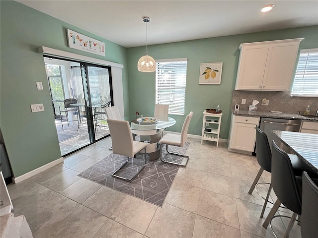 tiled dining room with a wealth of natural light