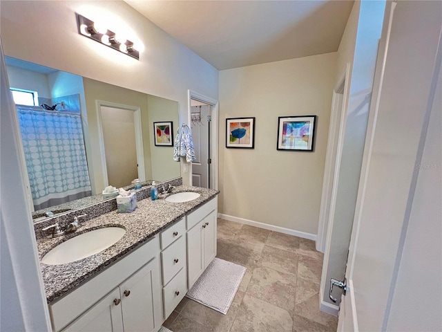 bathroom featuring vanity and curtained shower