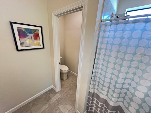 bathroom with a shower with curtain and toilet