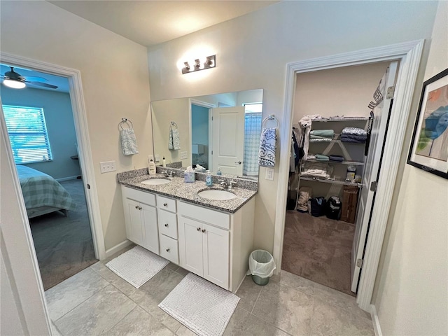 bathroom with tile patterned floors, vanity, and ceiling fan