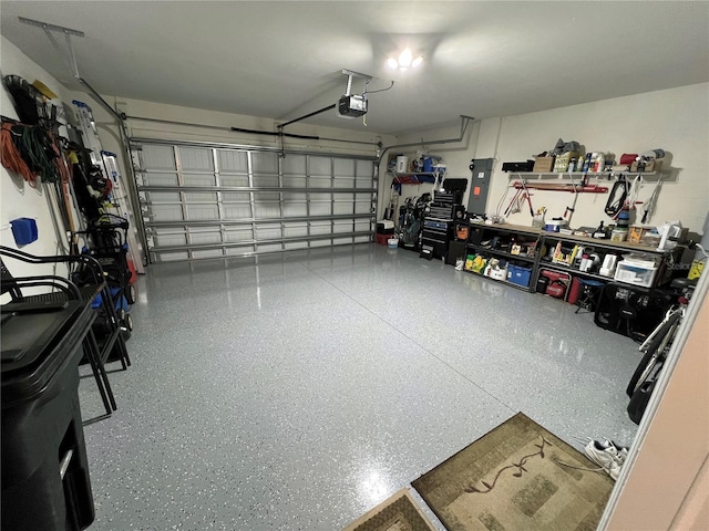 garage featuring electric panel and a garage door opener