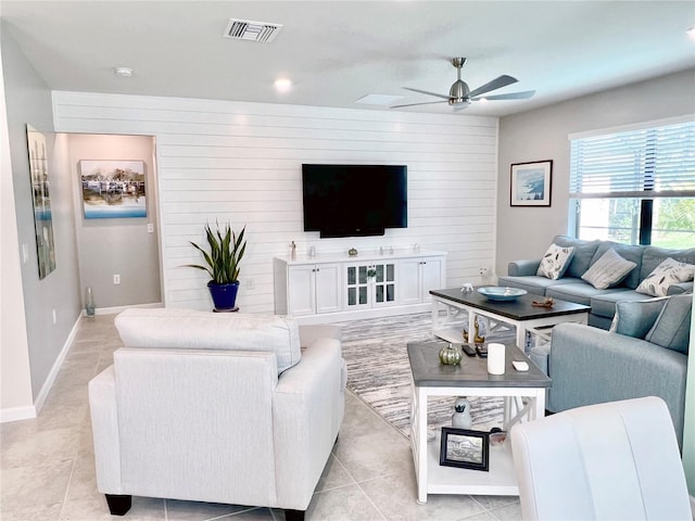 living room featuring ceiling fan and light tile patterned flooring