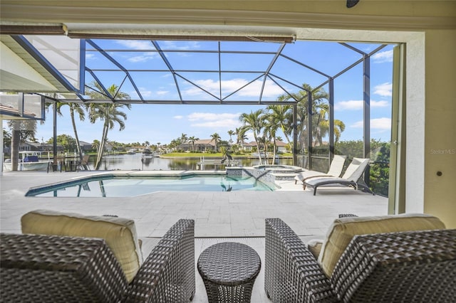 view of pool featuring a patio area, a water view, a lanai, and a pool with connected hot tub