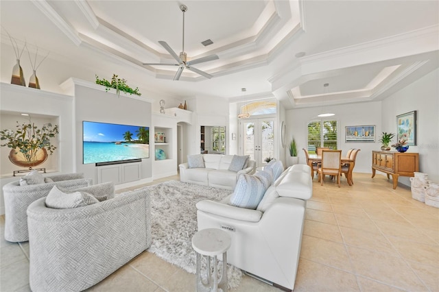 living area featuring light tile patterned floors, ornamental molding, and a raised ceiling