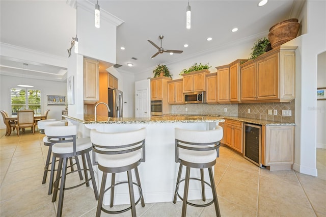 kitchen featuring stainless steel appliances, beverage cooler, kitchen peninsula, pendant lighting, and light tile patterned floors