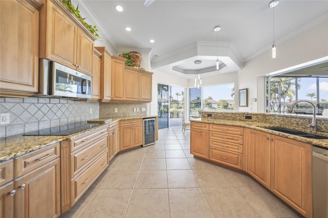 kitchen with ornamental molding, stainless steel appliances, sink, decorative light fixtures, and wine cooler