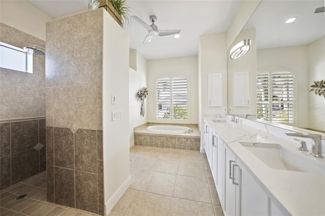 bathroom featuring tile patterned flooring, a garden tub, a sink, and walk in shower