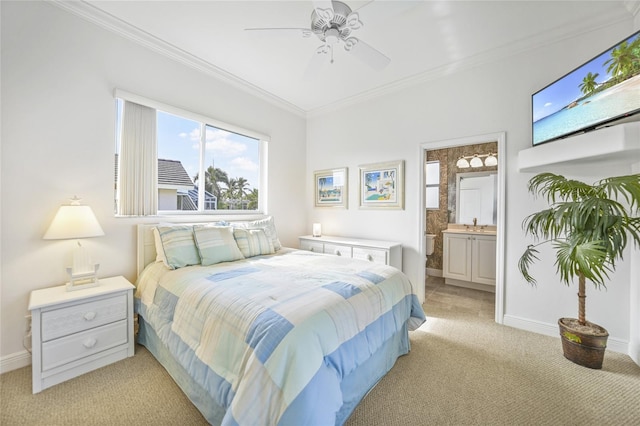 bedroom with crown molding, ensuite bathroom, a ceiling fan, light carpet, and baseboards