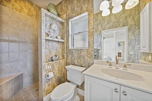 bathroom with walk in shower, vanity, toilet, and wallpapered walls