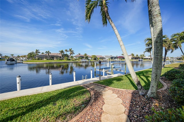 dock area featuring a water view and a lawn