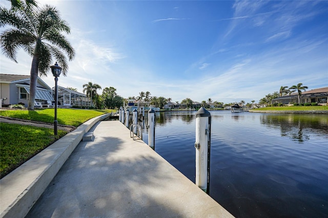 dock area with a yard and a water view