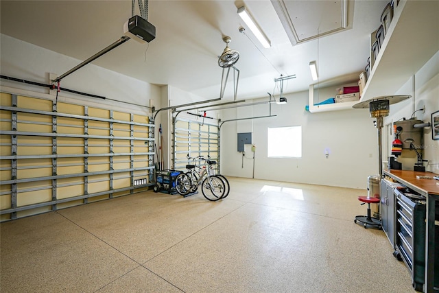 garage with a garage door opener and electric panel