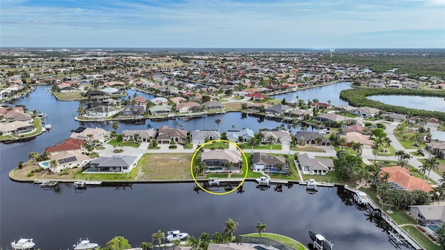 birds eye view of property featuring a water view and a residential view