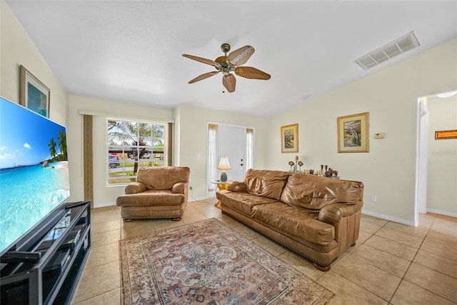 tiled living room with ceiling fan