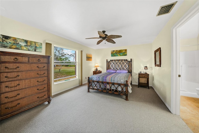 carpeted bedroom featuring ensuite bath and ceiling fan