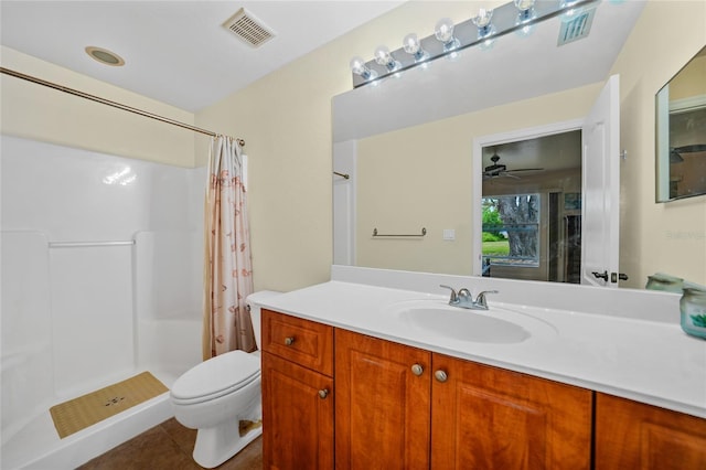 bathroom featuring vanity, tile patterned floors, ceiling fan, toilet, and walk in shower