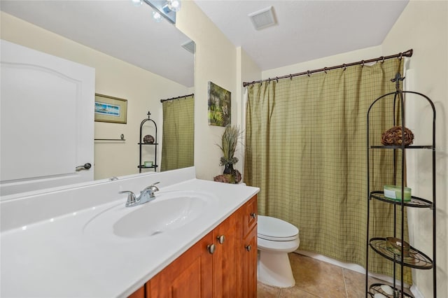 bathroom featuring tile patterned floors, vanity, and toilet