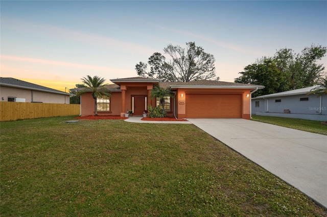 view of front of house with a lawn and a garage