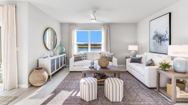 living room with ceiling fan and hardwood / wood-style flooring