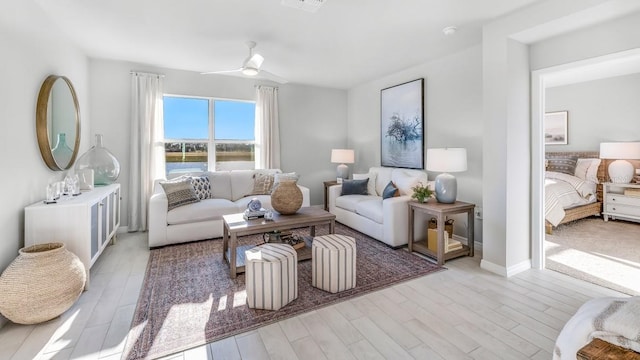 living room featuring ceiling fan and light hardwood / wood-style floors