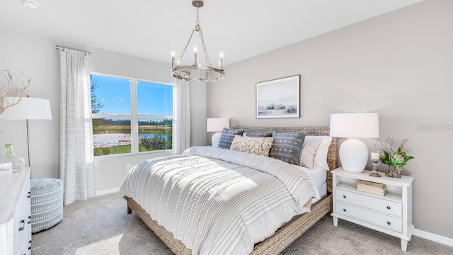 bedroom with light carpet and a notable chandelier