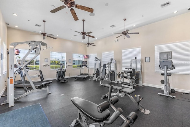 exercise room with a towering ceiling