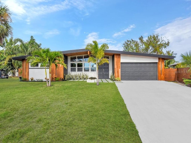 ranch-style house featuring a front lawn and a garage