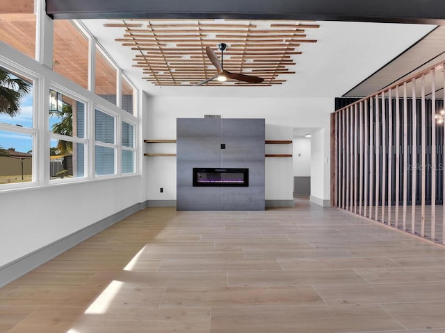 unfurnished living room with a towering ceiling and light hardwood / wood-style floors