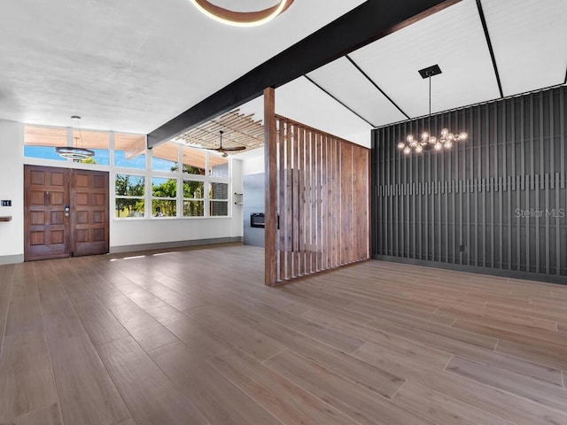 unfurnished living room featuring vaulted ceiling with beams, ceiling fan, and hardwood / wood-style floors