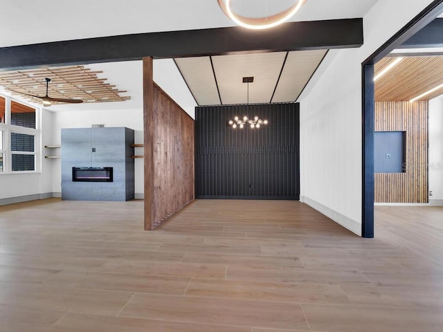 interior space featuring vaulted ceiling with beams, light hardwood / wood-style floors, and ceiling fan