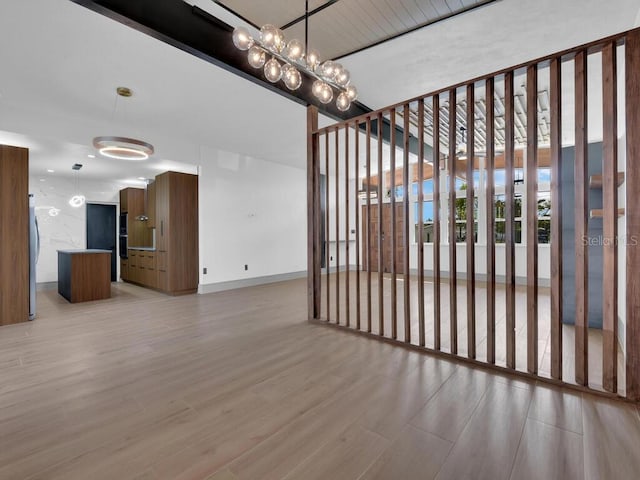 interior space with light hardwood / wood-style floors and a notable chandelier