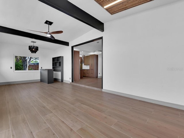 unfurnished living room with lofted ceiling with beams, light hardwood / wood-style floors, and ceiling fan with notable chandelier