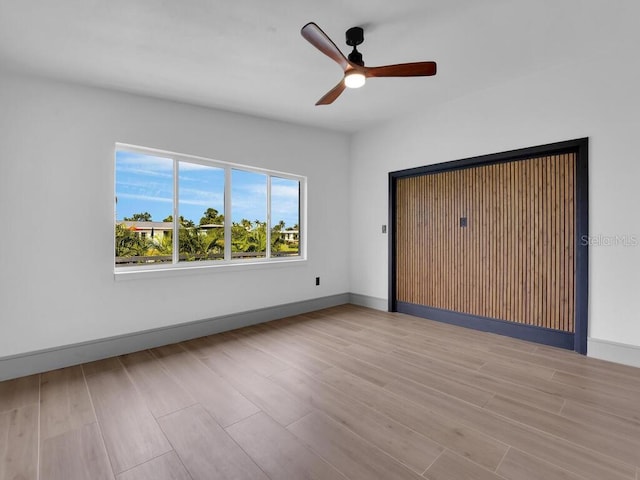 unfurnished bedroom featuring ceiling fan and light wood-type flooring