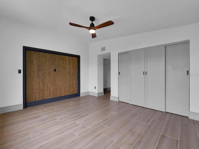 unfurnished bedroom featuring ceiling fan and light hardwood / wood-style floors