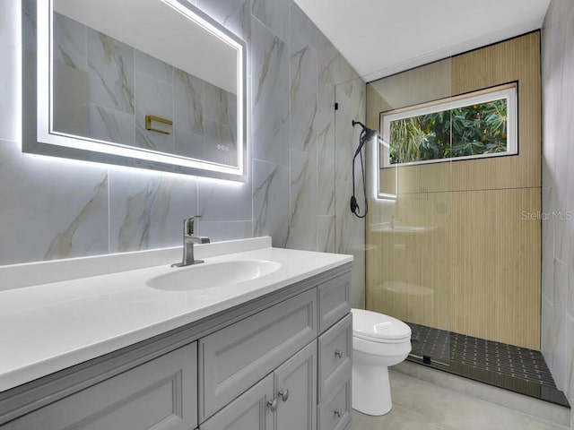 bathroom with decorative backsplash, vanity, tiled shower, tile walls, and toilet