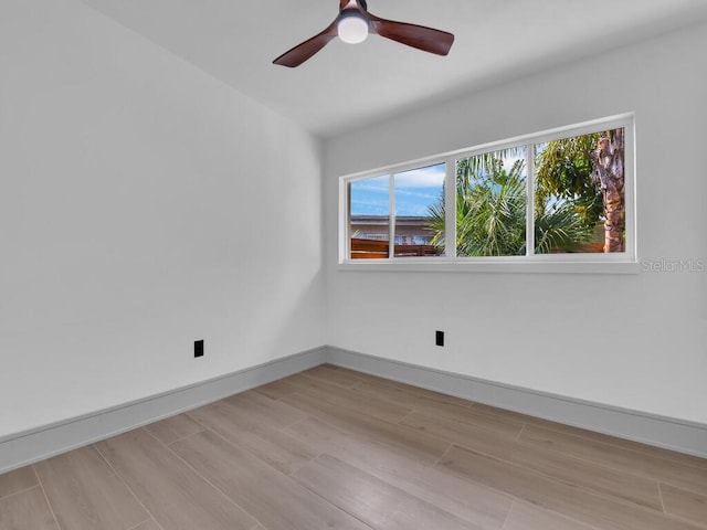 spare room with ceiling fan and light hardwood / wood-style flooring