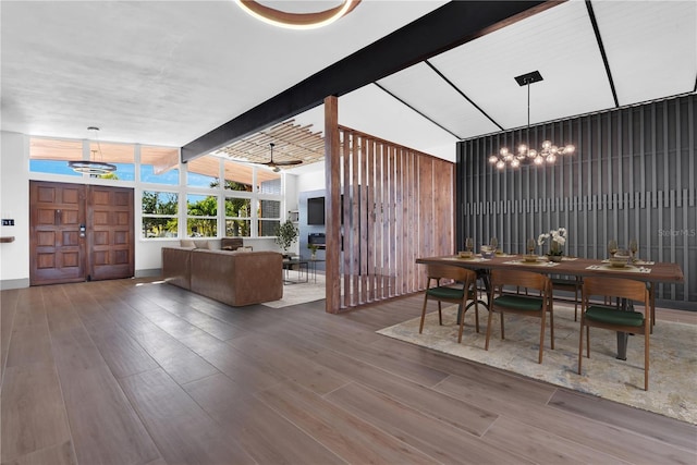 dining area with expansive windows, hardwood / wood-style flooring, and ceiling fan