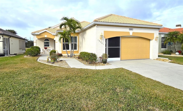 mediterranean / spanish-style house featuring a front lawn and a garage