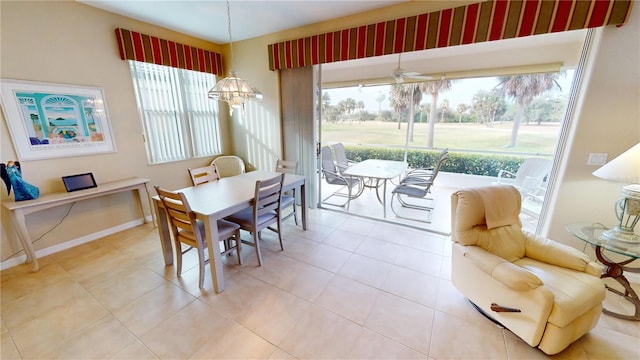 dining space with a wealth of natural light, ceiling fan, and light tile patterned floors