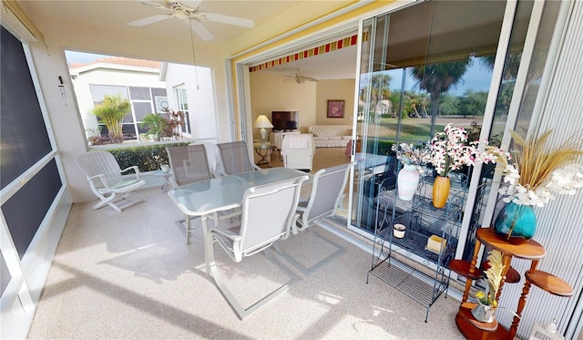 sunroom featuring ceiling fan