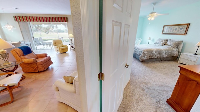 bedroom with light tile patterned floors, access to outside, and ceiling fan