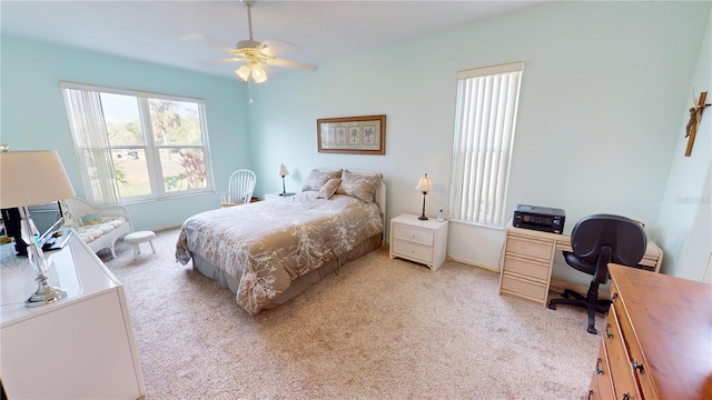 bedroom with ceiling fan and light carpet