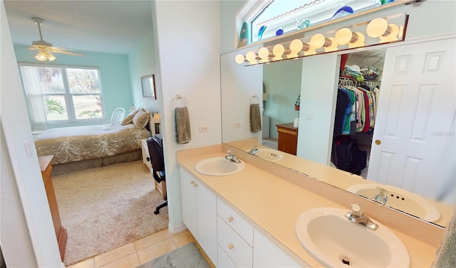 bathroom with tile patterned flooring, vanity, and ceiling fan