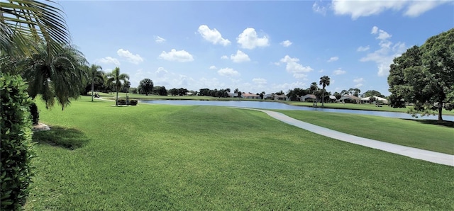 view of home's community featuring a water view and a yard