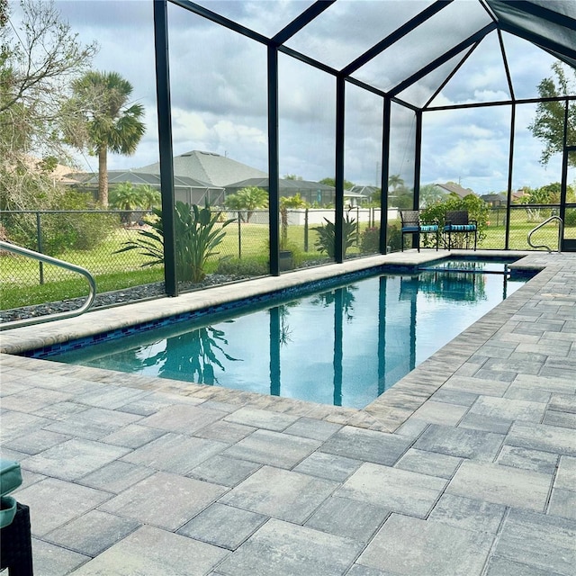 view of swimming pool with a lanai, a patio, and a yard