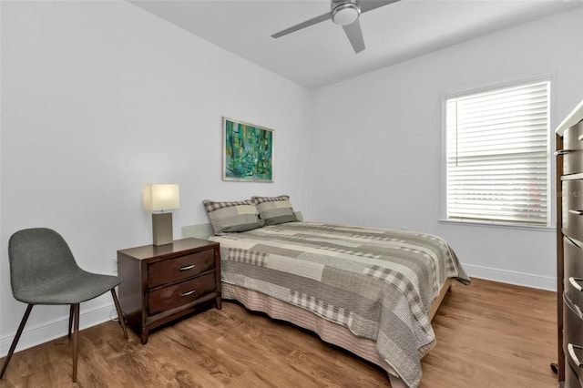 bedroom with ceiling fan and light hardwood / wood-style floors